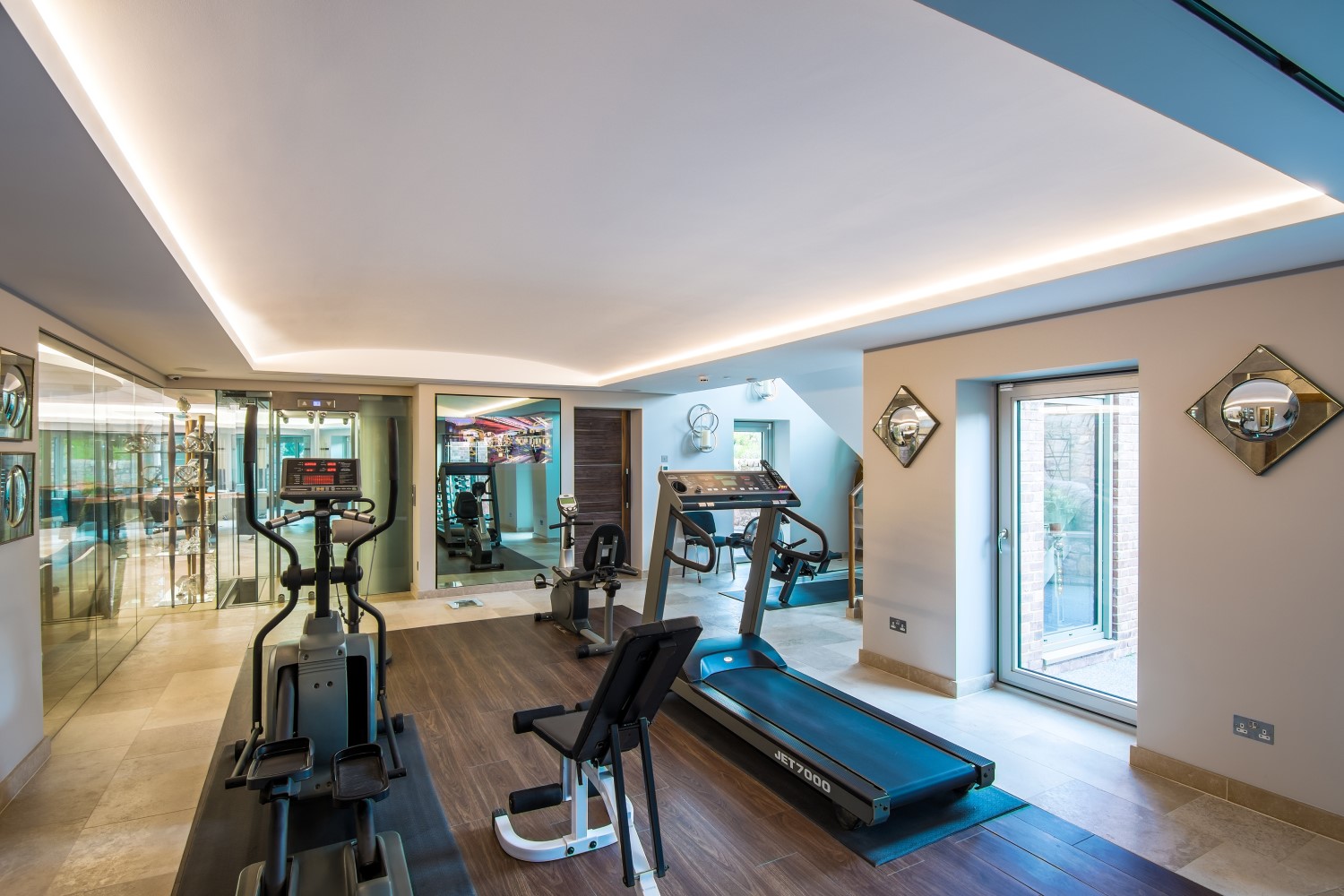 Gym with embedded Lutron lighting features in ceiling.