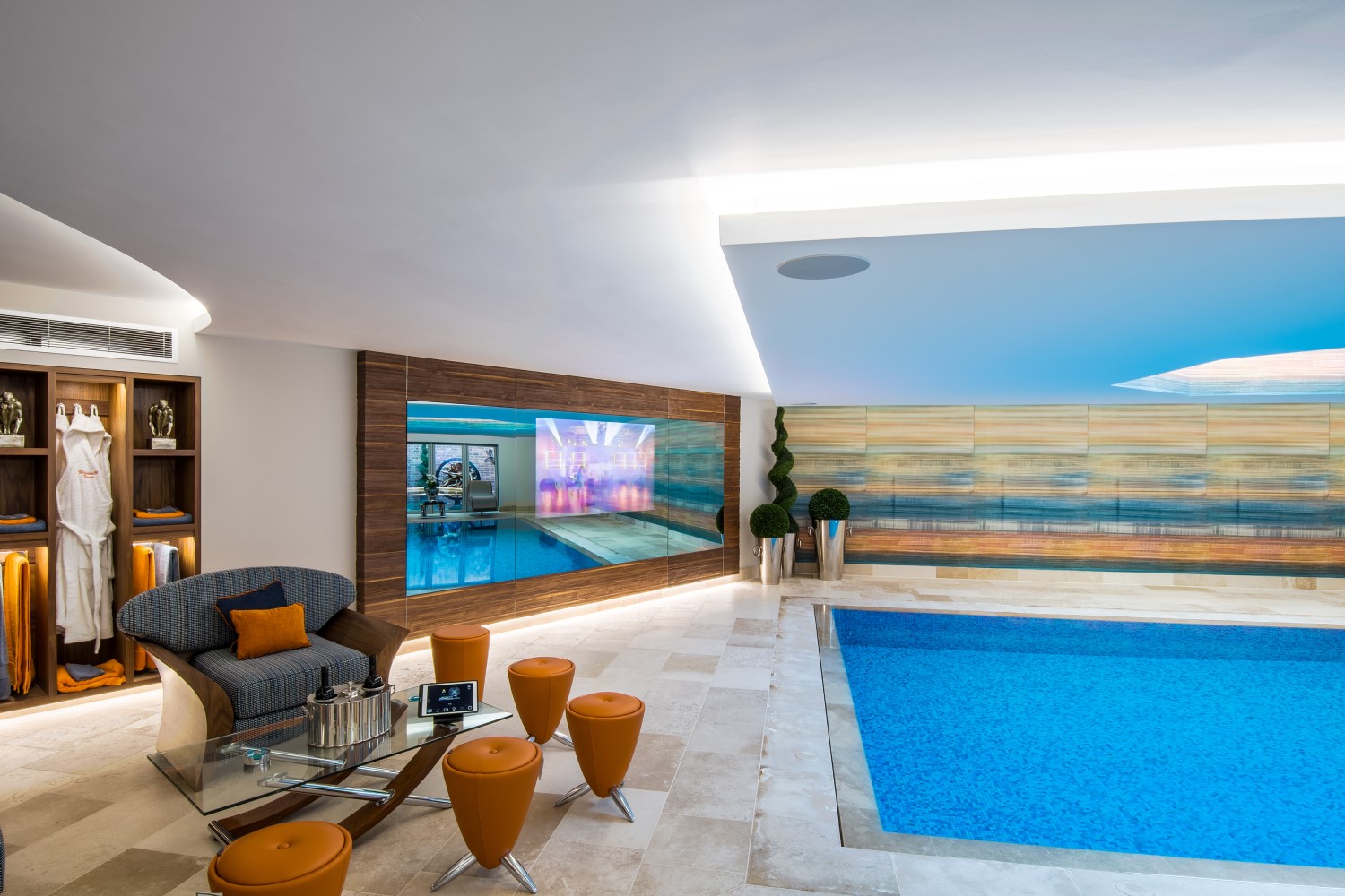 Indoor pool area featuring embedded Lutron lighting and modern decor.